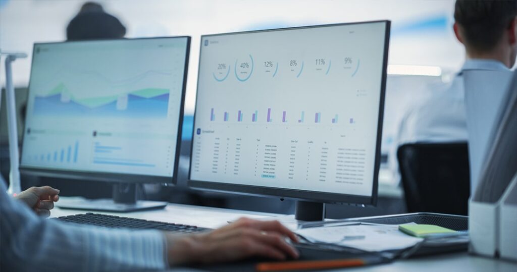 Shot of an unidentifiable businessman working on a laptop in an office